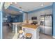 Modern kitchen with gray cabinets, island, and stainless steel appliances at 561 Juniper Springs Dr, Groveland, FL 34736