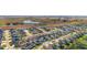 Aerial view of a community with houses, roads, and a lake at 6714 Newell Loop, The Villages, FL 34762