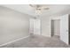 Bedroom with ceiling fan, closet, and carpeted floor at 10013 Stockbridge St, Clermont, FL 34711