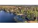 Wide aerial showcasing a home nestled on a wooded lakeside lot at 10285 Ne 218Th Lane Rd, Fort Mc Coy, FL 32134