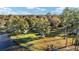 Aerial view showcasing a lakeside property with several buildings and green space at 10285 Ne 218Th Lane Rd, Fort Mc Coy, FL 32134