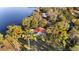 Aerial view of a home with red roof near a lake and surrounded by trees at 10285 Ne 218Th Lane Rd, Fort Mc Coy, FL 32134