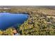 An aerial view of a home nestled in a wooded area near a lake at 10285 Ne 218Th Lane Rd, Fort Mc Coy, FL 32134