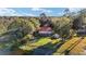 Aerial view of lakefront property with lush trees and multiple buildings at 10285 Ne 218Th Lane Rd, Fort Mc Coy, FL 32134