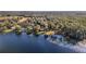 Aerial view of waterfront property with homes and surrounding woods at 10285 Ne 218Th Lane Rd, Fort Mc Coy, FL 32134
