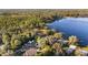 Aerial view showcasing a lakefront property with various structures and surrounding greenery at 10285 Ne 218Th Lane Rd, Fort Mc Coy, FL 32134