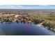 Aerial close-up view of a lakefront home surrounded by trees at 10285 Ne 218Th Lane Rd, Fort Mc Coy, FL 32134