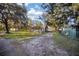 Landscaped backyard with grassy area and mature trees at 10285 Ne 218Th Lane Rd, Fort Mc Coy, FL 32134