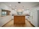 Modern kitchen with white cabinets, island, and stainless steel appliances at 10285 Ne 218Th Lane Rd, Fort Mc Coy, FL 32134