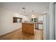 Well-lit kitchen with white cabinets, an island, and wood flooring at 10285 Ne 218Th Lane Rd, Fort Mc Coy, FL 32134