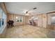 Open living room with wood paneling, tile floors, and kitchen view at 10285 Ne 218Th Lane Rd, Fort Mc Coy, FL 32134