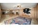Bright living room with wood paneling, tile floors, and kitchen view at 10285 Ne 218Th Lane Rd, Fort Mc Coy, FL 32134