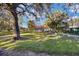Large grassy side yard with mature trees and a shed at 10285 Ne 218Th Lane Rd, Fort Mc Coy, FL 32134