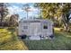 Rustic metal storage shed with windows and wood entryway at 10285 Ne 218Th Lane Rd, Fort Mc Coy, FL 32134