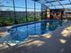 Inviting screened pool with spacious deck at 1107 N Valencia Ave, Howey In The Hills, FL 34737