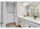 Double vanity bathroom with modern fixtures and a large mirror at 13245 Peaceful Melody Dr, Winter Garden, FL 34787