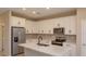 Modern kitchen with white cabinets, quartz countertops, and stainless steel appliances at 13245 Peaceful Melody Dr, Winter Garden, FL 34787