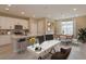 Open concept kitchen and dining area, featuring modern cabinetry and a large island at 13245 Peaceful Melody Dr, Winter Garden, FL 34787
