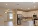 Modern kitchen with stainless steel appliances and an open view to the foyer at 13245 Peaceful Melody Dr, Winter Garden, FL 34787