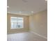 Bright and airy living room with large windows and neutral walls at 13245 Peaceful Melody Dr, Winter Garden, FL 34787
