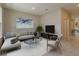 Spacious living room featuring a sectional sofa, large TV, and neutral decor at 13245 Peaceful Melody Dr, Winter Garden, FL 34787