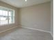Small home office space with large window and neutral color scheme at 13245 Peaceful Melody Dr, Winter Garden, FL 34787