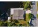 Aerial view of house on the lake with dock and boat at 13724 Country Club Dr, Tavares, FL 32778
