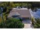 Lakefront home with driveway and garage at 13724 Country Club Dr, Tavares, FL 32778