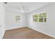 Bright bedroom with new carpet, ceiling fan, and large windows at 13724 Country Club Dr, Tavares, FL 32778