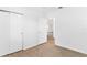 Bright bedroom with wood-look flooring and access to another room at 13724 Country Club Dr, Tavares, FL 32778