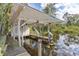 Covered boat lift provides convenient water access at 13724 Country Club Dr, Tavares, FL 32778