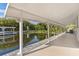 Long covered patio with water access and tranquil views at 13724 Country Club Dr, Tavares, FL 32778