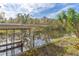 Wooden dock extending over calm water, offering serene waterfront views at 13724 Country Club Dr, Tavares, FL 32778