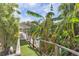 Lush landscaping leads to a waterfront dock and walkway at 13724 Country Club Dr, Tavares, FL 32778
