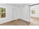 Bright entryway with barn door and neutral carpeting at 13724 Country Club Dr, Tavares, FL 32778