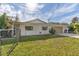 White brick ranch house with attached garage and fenced yard at 13724 Country Club Dr, Tavares, FL 32778