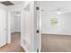 Hallway view of bedrooms with neutral carpeting at 13724 Country Club Dr, Tavares, FL 32778