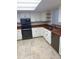 White kitchen cabinets and wood countertops at 13724 Country Club Dr, Tavares, FL 32778