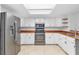 Modern kitchen, featuring stainless steel appliances and wood countertops at 13724 Country Club Dr, Tavares, FL 32778