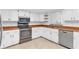 Updated kitchen with stainless steel appliances and white cabinets at 13724 Country Club Dr, Tavares, FL 32778