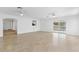 Large living area with tile floors and access to other rooms at 13724 Country Club Dr, Tavares, FL 32778