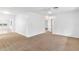 Spacious living room with neutral carpeting and access to other rooms at 13724 Country Club Dr, Tavares, FL 32778