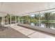 Relaxing screened porch overlooking a pond at 13724 Country Club Dr, Tavares, FL 32778