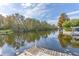 Scenic canal view with lush trees and a wooden dock at 13724 Country Club Dr, Tavares, FL 32778