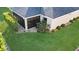 Screened-in patio with lush landscaping at 1494 Walnut Way, The Villages, FL 32163