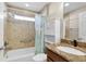 Bathroom with tub shower, granite vanity and linen closet at 1494 Walnut Way, The Villages, FL 32163