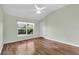 Light and airy bedroom featuring wood floors and a window with a view at 1494 Walnut Way, The Villages, FL 32163