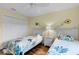 Guest bedroom with twin beds and wood floors at 1494 Walnut Way, The Villages, FL 32163
