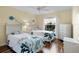 Guest bedroom with twin beds and wood floors at 1494 Walnut Way, The Villages, FL 32163