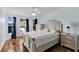 Bedroom with wood floors and large window at 1494 Walnut Way, The Villages, FL 32163